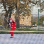 Santa has a quick game of tennis